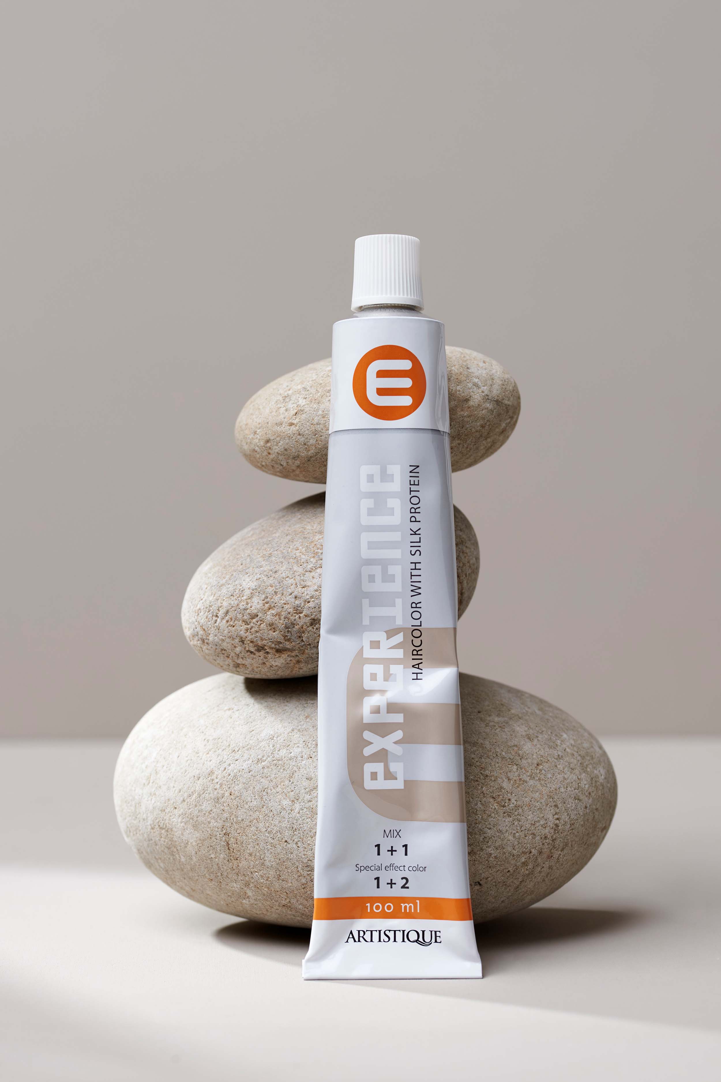 Product photography for Artistique - hair care product with creative styling and professional lighting